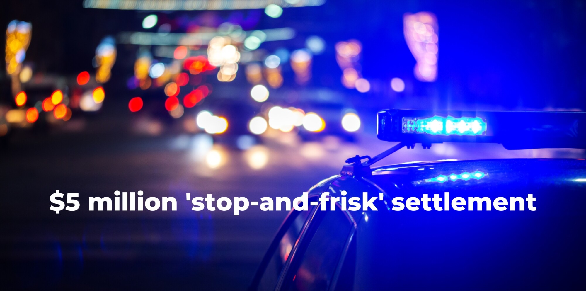 Image of police car making a stop at night.
